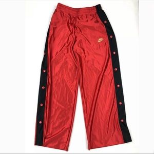 Red silk nike snap pants with gold embroidery